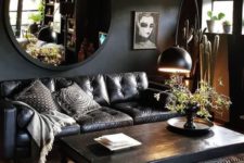 16 a dark living room with a boho feel, a printed rug and quirky artworks and pillows