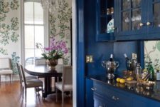 16 a home bar with classic blue cabinets with glass doors looks chic and refined and adds a trendy touch to the space