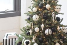 19 a stylish modern Christmas tree with lights and printed oversized black and white ornaments plus a striped skirt