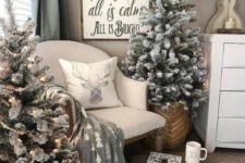 20 two flocked Christmas trees with lights placed into baskets are nice for a cozy farmhouse feel in the space