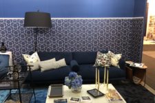 21 a living room with a classic blue wall with added geometric prints and a matching blue rug for a trendy touch
