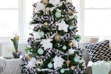 23 a farmhouse Christmas tree with fkuffy and buffalo check ribbons, mint green ornaments and oversized white flowers