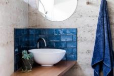 25 a small classic blue tile backsplash aroudn the sink and some matching towels for a bold touch in the bathroom