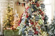 25 mismatching Christmas trees – all flocked but decorated with different ornaments, with no ornaments and only lights