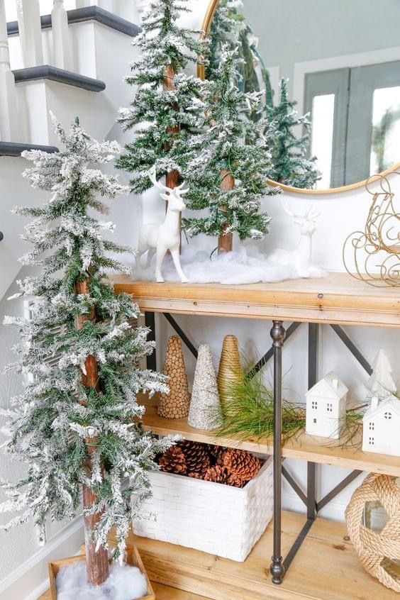 Christmas console decor with flocked Christmas trees, cone trees, deer and pinecones in a box is amazing