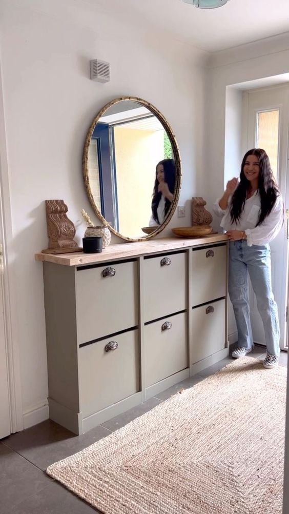 a cool entryway console table with storage made of several IKEA Bissa pieces, with a wooden countertop and metal handles