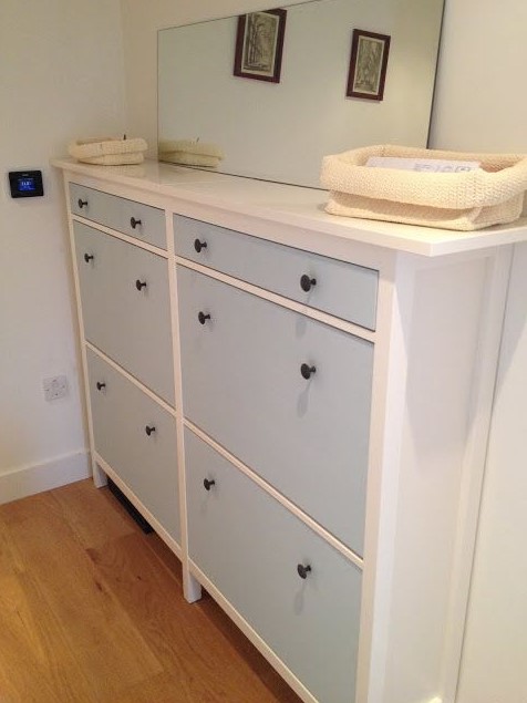 a cute IKEA Hemnes shoe storage in light blue with black knobs is ideal for a kids' space