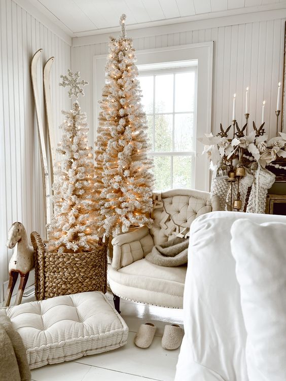 a cute duo of white Christmas trees with lights and snowflakes will bring a soft holiday feel to the space