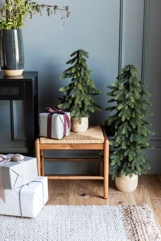 a duo of Christmas trees in planters is a cool solution for a modern or Scandinavian space