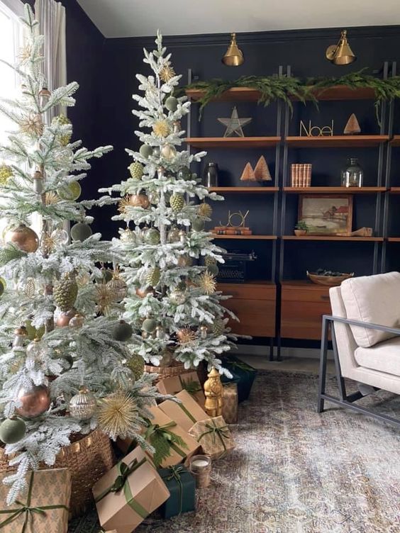 a duo of large Christmas trees with green and brown ornaments and baskets is a cool decor idea for the holidays