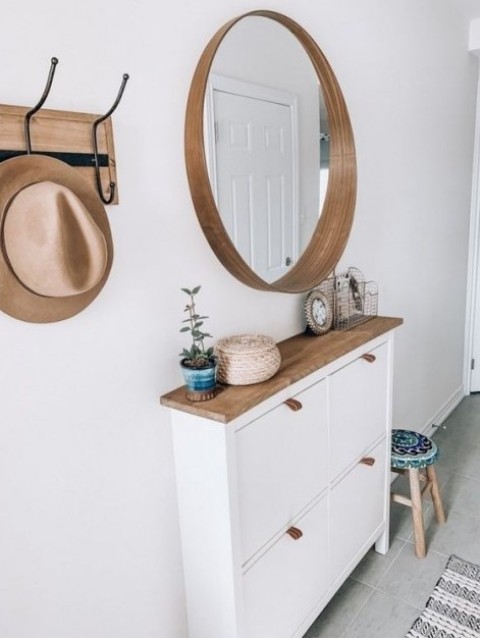 a sleek entryway console table of an IKEA Hemnes cabinet with a wooden top and leather pulls