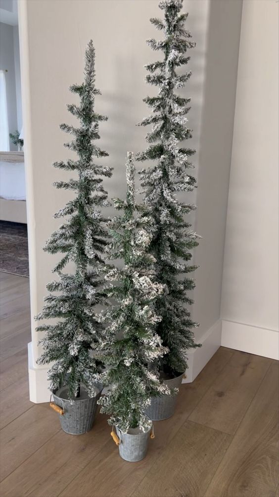 a small cluster of tall flocked Christmas trees will instantly bring a farmhouse feel to the space