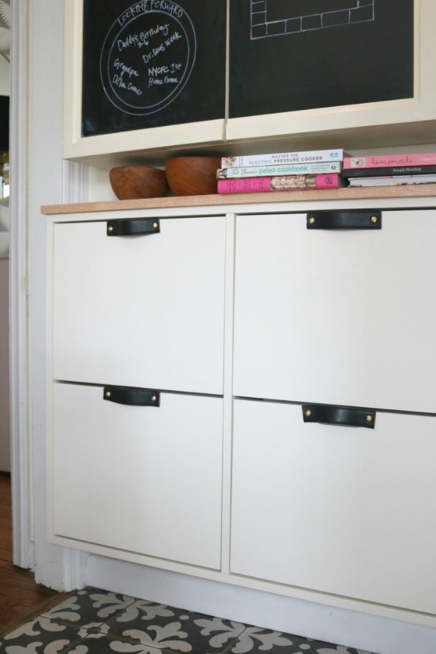 a stylish modern IKEA Stall hack with black leather handles and a wooden countertop for a chic look