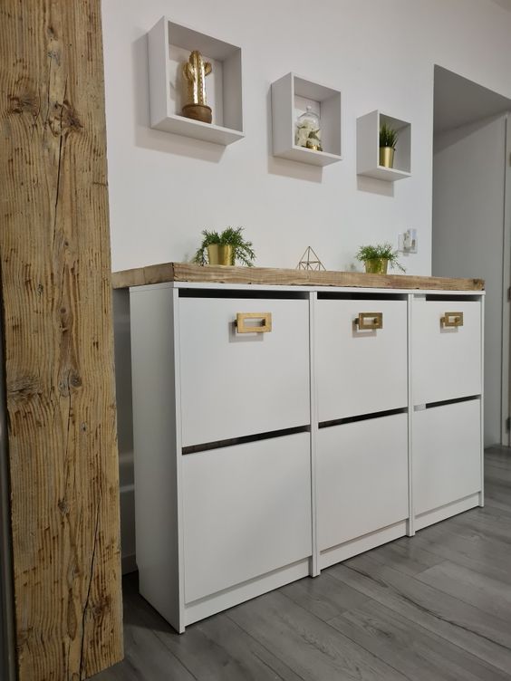 a white IKEA Bissa hack with a stained countertop and gold handles is a lovely solution for a boho or modern space