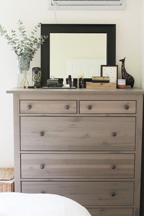 an IKEA Hemnes shoe cabinet given a chic look with wood stain and wooden knobs for a rustic feel