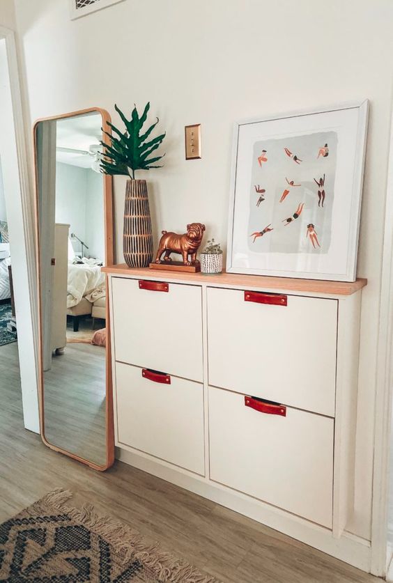 an IKEA Stall hack with leather pulls and a wooden countertop is a cool and stylish idea for a modern or boho space