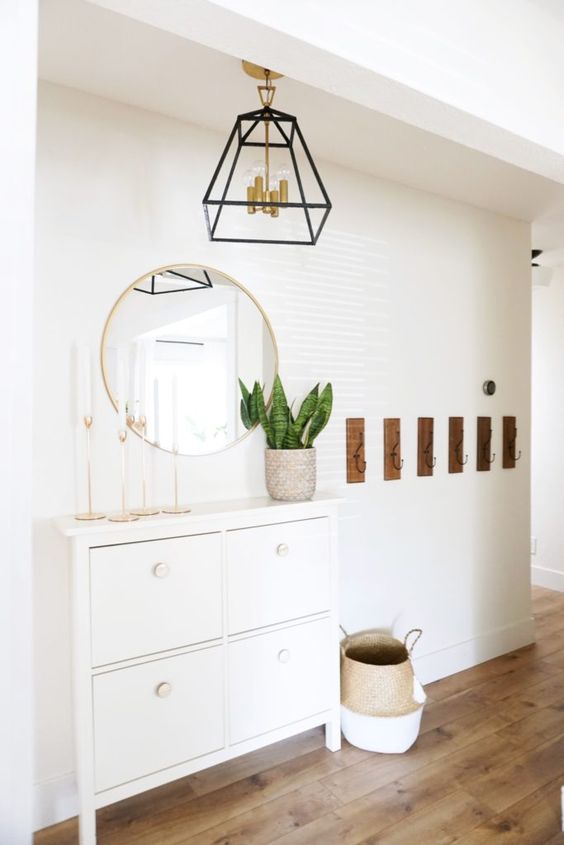 an elegant IKEA Stall hack with white knobs and tall legs is a stylish idea for a boho space