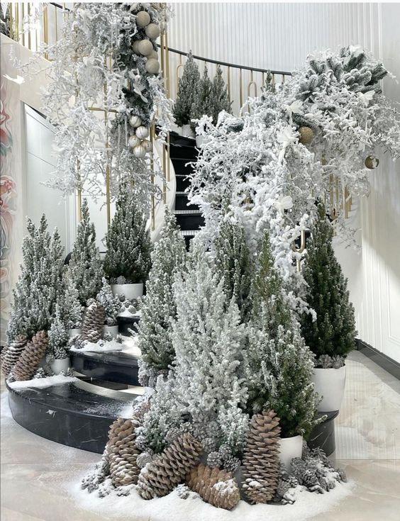 jaw-dropping Christmas stairs decor with multiple potted trees, oversized pinecones and some ornaments and branches