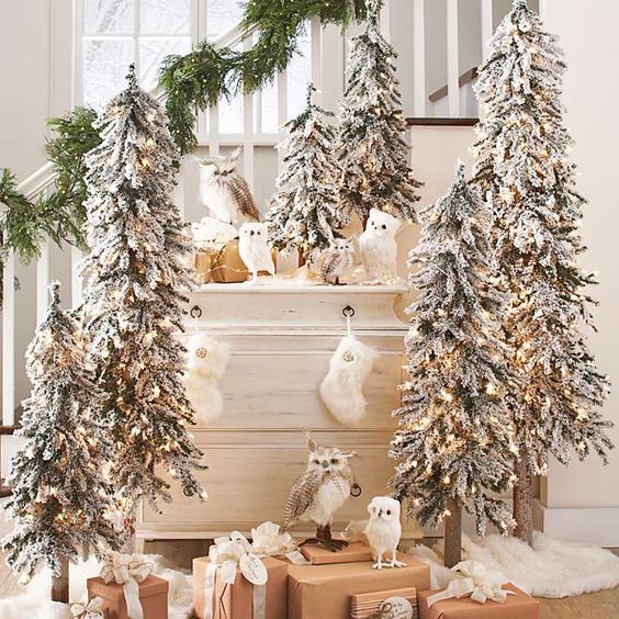 multiple flocked Christmas trees, faux owls and sotckings are amazing for farmhouse Christmas decor