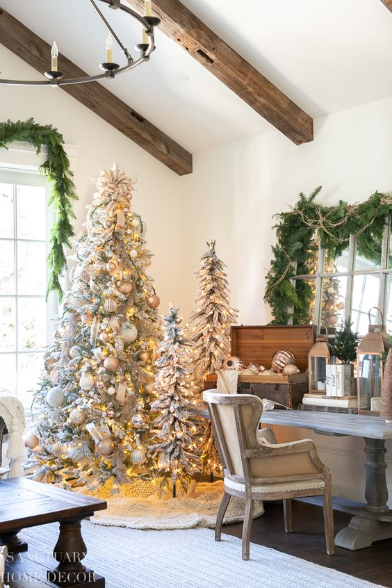 multiple flocked Christmas trees with lights, metallic and white ornaments are perfect for rustic holiday decor