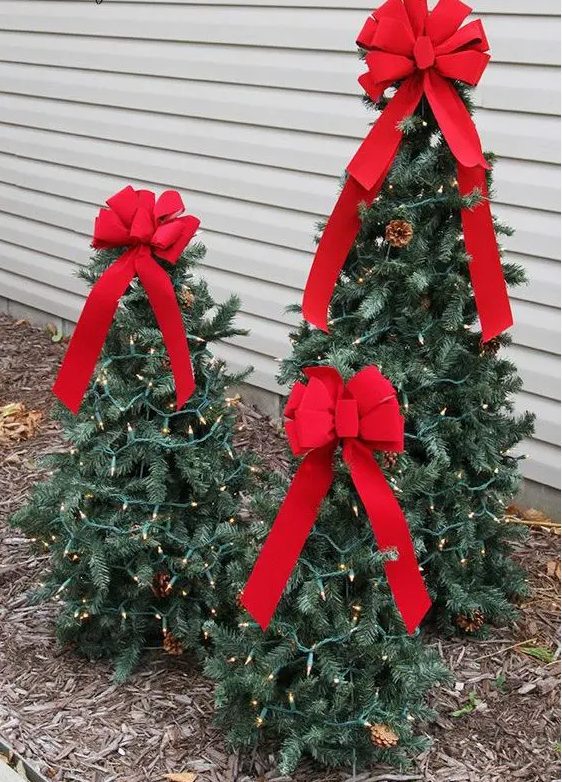 tiered tomato cage Christmas trees with lights and red bows can be DIYed for outdoor holiday decor