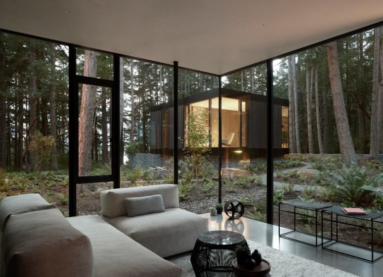 Glazed walls connect the spaces to outdoors and open them up, a neutral color palette doesn't distract from the views