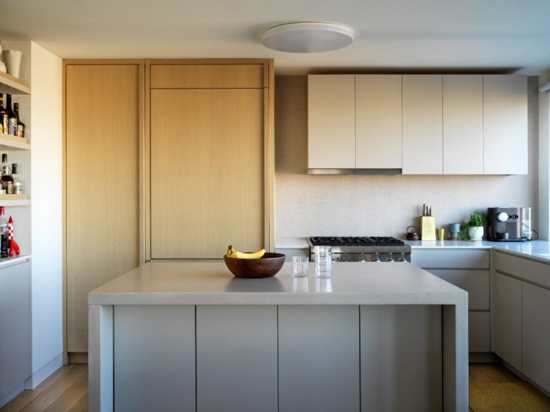 The kitchen is done in neutrals, with sleek surfaces, comfortable shelving and mostly hidden storage units The kitchen is done in neutrals, with sleek surfaces, comfortable shelving and mostly hidden storage units