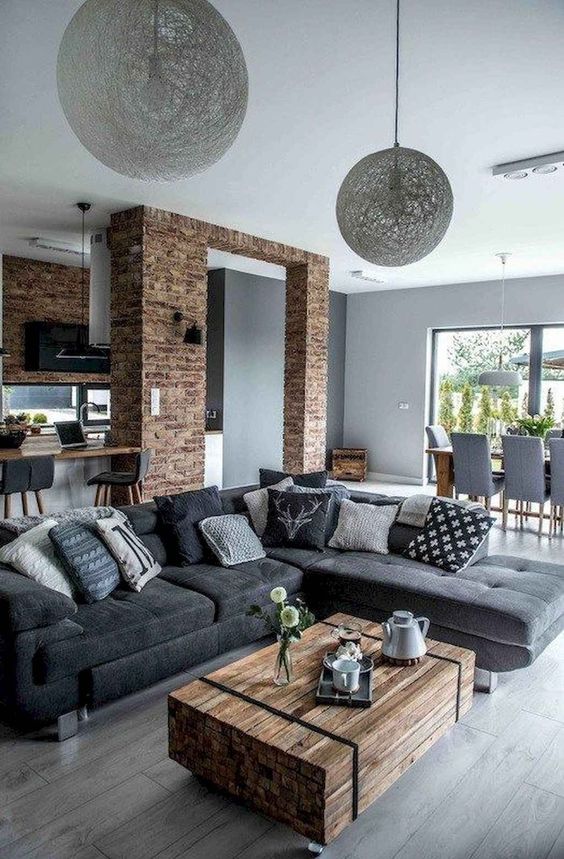a contemporary meets industrial living room with a grey laminate floor and furniture on legs