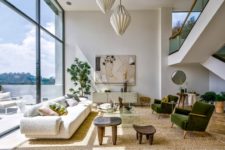 03 The living room is styled with chic furniture, a combo of 3D pendant lamps and cool art