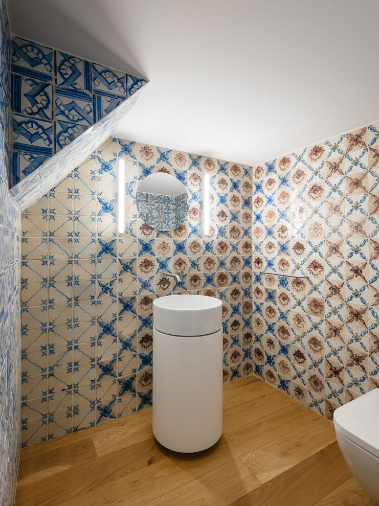 The powder room can boast of cool blue and white azulejo tiles for a bright and chic look