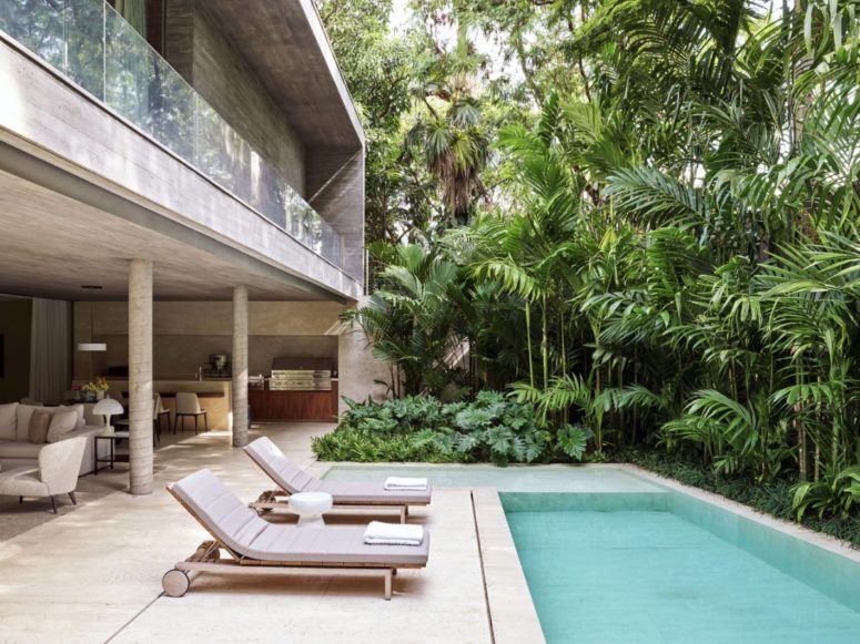 The living area extends outdoors and can become connected to the poolside deck