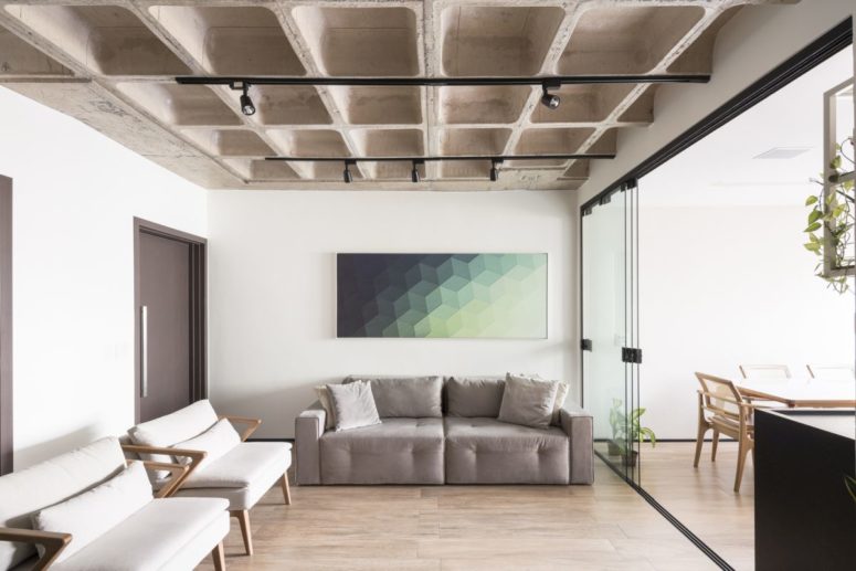 The living room is welcoming and cozy and has sliding glass doors that separate it from the kitchen and dining area The living room is welcoming and cozy and has sliding glass doors that separate it from the kitchen and dining area