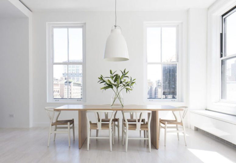 This is a dining space with a wooden table, white chairs and pendant lamps this space is filled with light and features cool views This is a dining space with a wooden table, white chairs and pendant lamps - this space is filled with light and features cool views