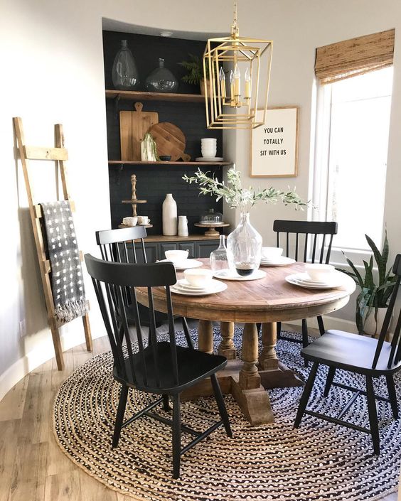 a farmhouse dining room with a vintage wooden table that sets the tone of the space and much texture