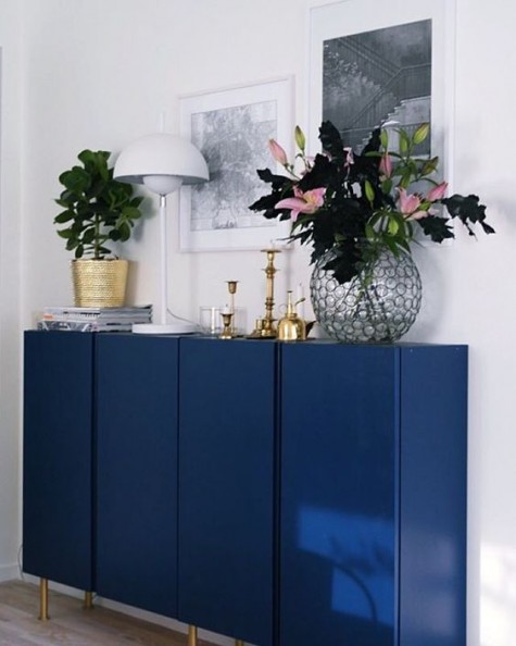 IKEA Ivar cabinets painted navy and with brass legs look super stylish and bold