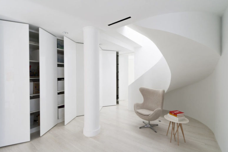 There's a sculptural staircase that leads to an open space with much hidden storage