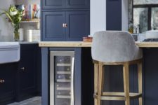 10 a retro navy kitchen with white and light-colored wood touches and touches of copper that make it feel cozy