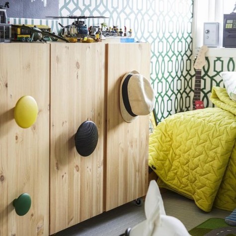 an IKEA Ivar cabinet spruced up with large round and colorful handles for a fresh modern look
