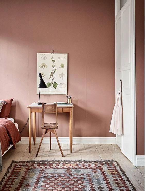 an earthy tone bedroom done in reddish tones and with plenty of patterns looks cool and inviting