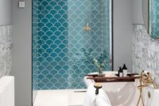 17 a shower space done with turquoise scallop shaped tiles that make it stand out a lot
