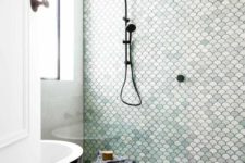 18 a neutral bathroom with a shower space done with aqua-colored scallop tiles that make it stand out