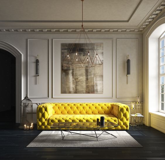 a super bold yellow tufted sofa makes a cool statement in a neutral space