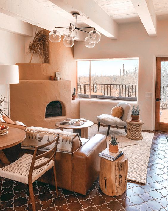 a cool and warm living room with an earthy tone hearth and a leather sofa, a rattan table and a stump