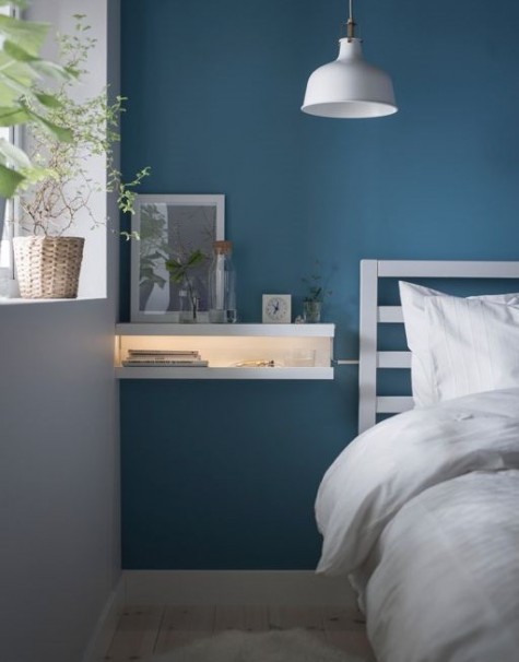 a minimalist nightstand made from two MOSSLANDA picture ledges stacked on each other with an LED strip inside