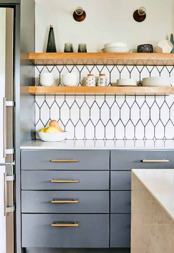 thick light-colored wooden shelving contrasts the graphic tile bakplash and looks cool