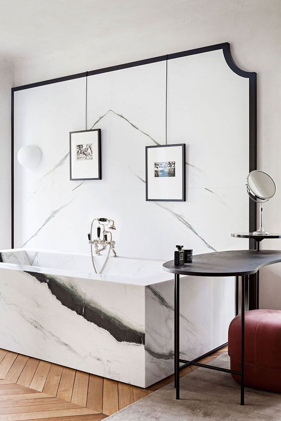 a luxurious bathroom with black and white marble with unique patterns that bring a unique look to the space