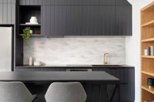 26 a dark kitchen with dark countertops is a stylish idea and a neutral backsplash adds contrast to the space