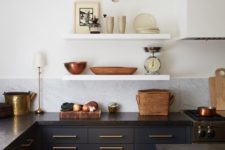 27 dark blue cabinets paired with black stone countertops and gold touches for a super chic look