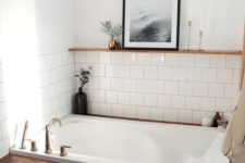 35 a cozy bathroom niche done with white tiles and a bathtub clad with stained wood