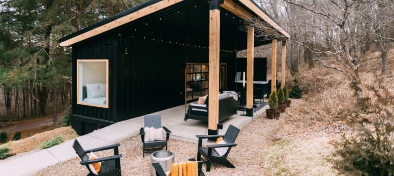 The angled roof is supported by wooden beams and seamlessly connects the spaces
